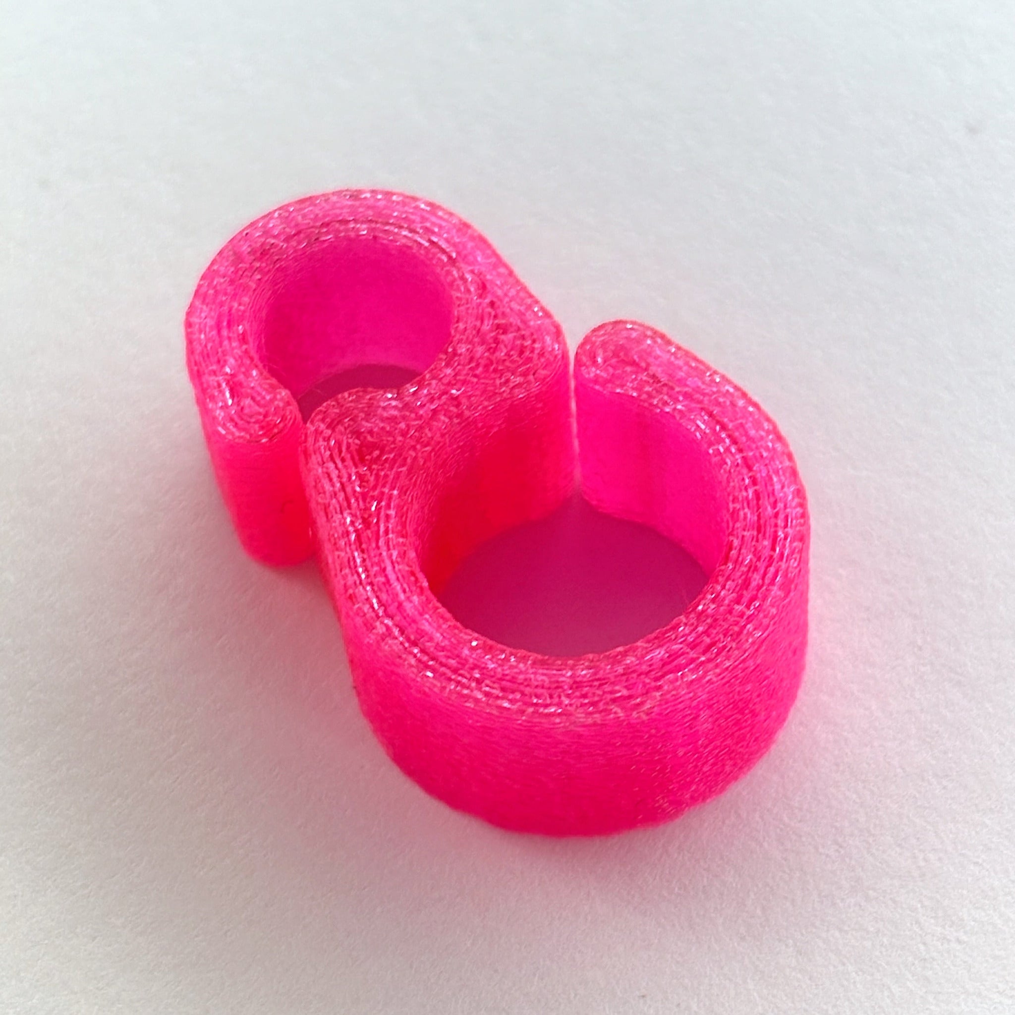 Pink 3D-printed object on a white background