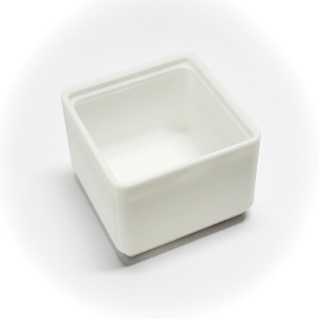 A small square white plastic gridfinity bin, photographed on a clean white background with a soft shadow.