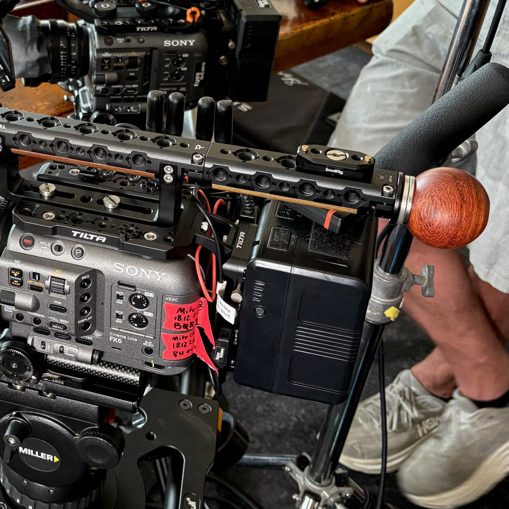 Close-up of a Sony camera rig with a wooden ball handle like beeball
