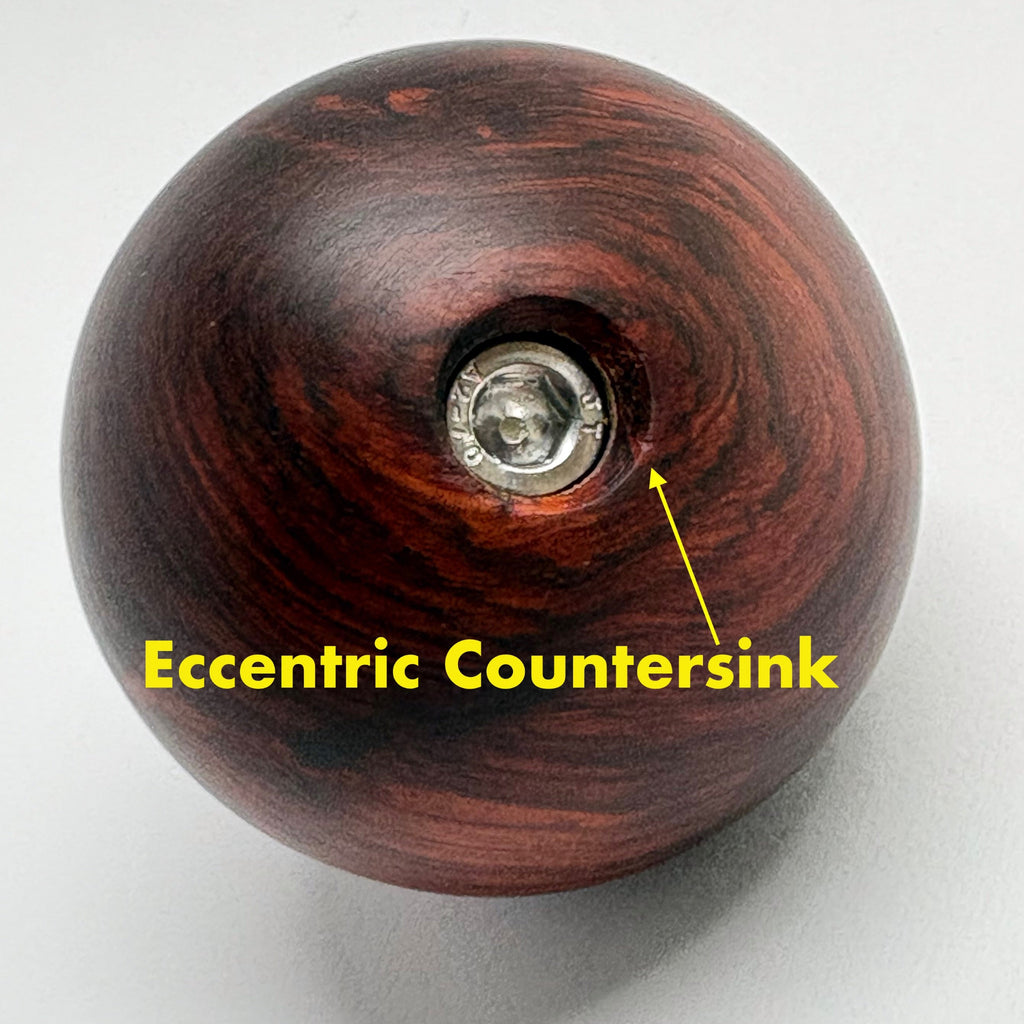 Wooden knob with an eccentric countersink on a white background