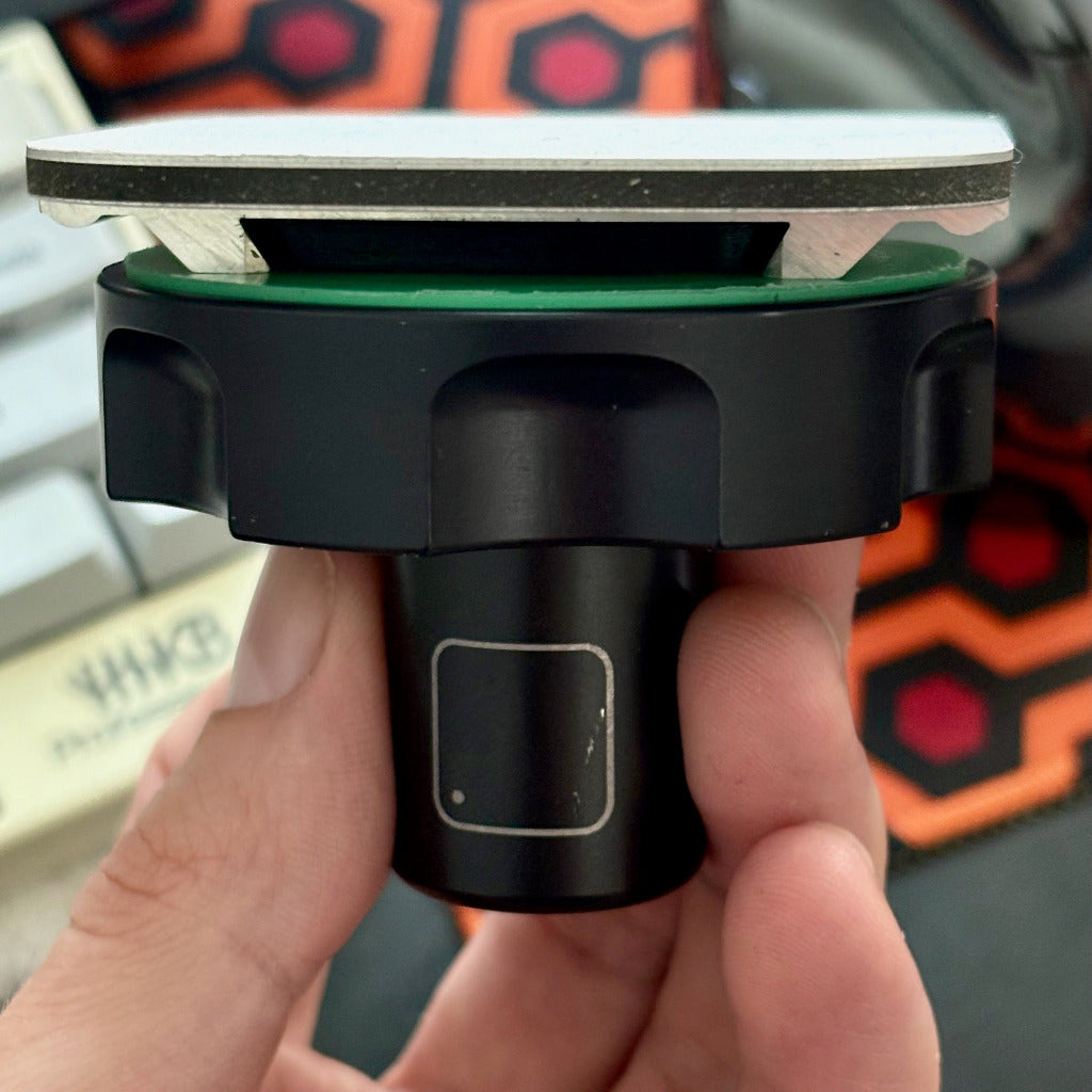 Hand holding a Lightbridge CLRS mount with replacement safety wedge