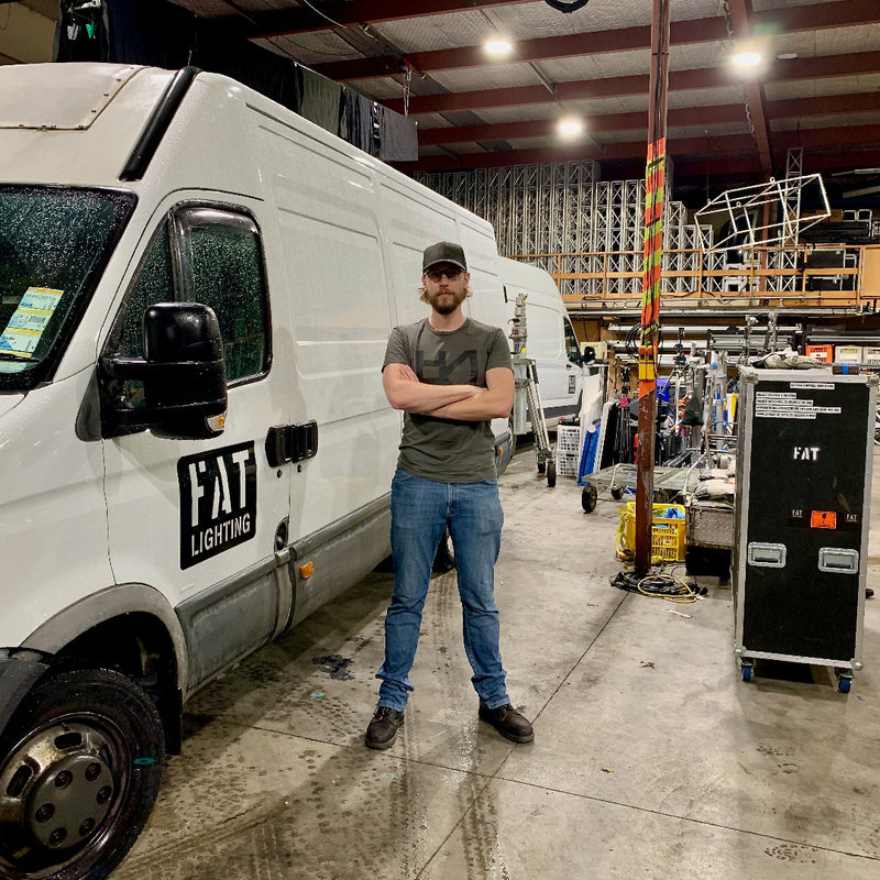 Gaffer standing in front of film lighting van