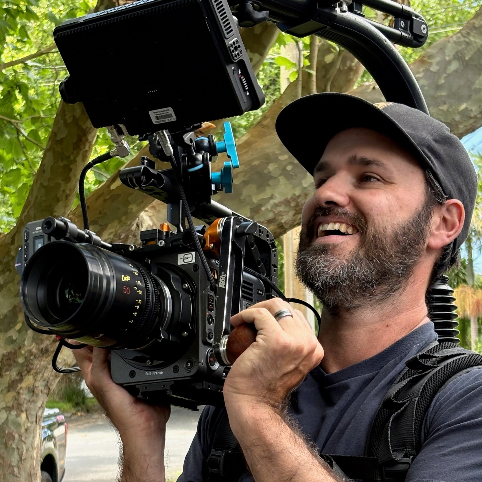 Man holding a SOny Burano camera with Cooke S4 lens with Wooden Ball Handle on a Mantis and Easyrig.