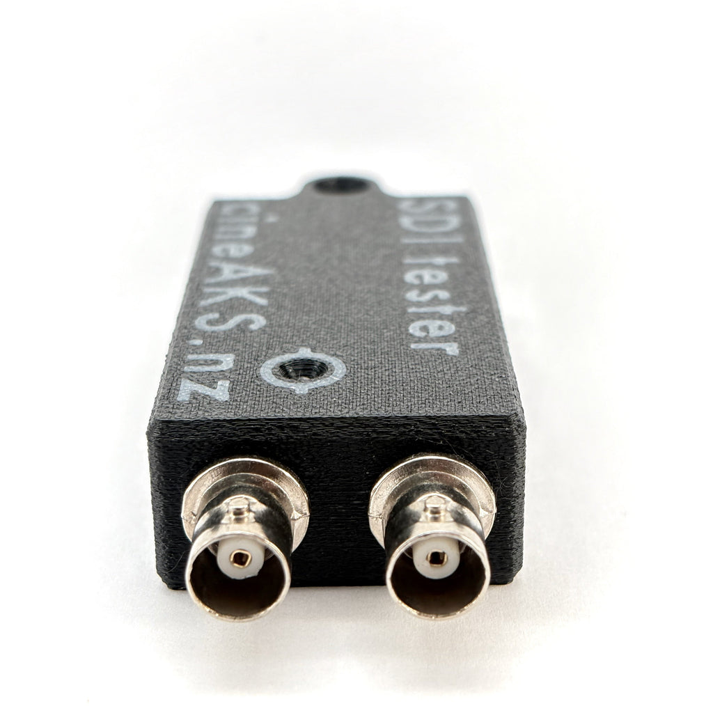 SDI tester with two connectors on a white background