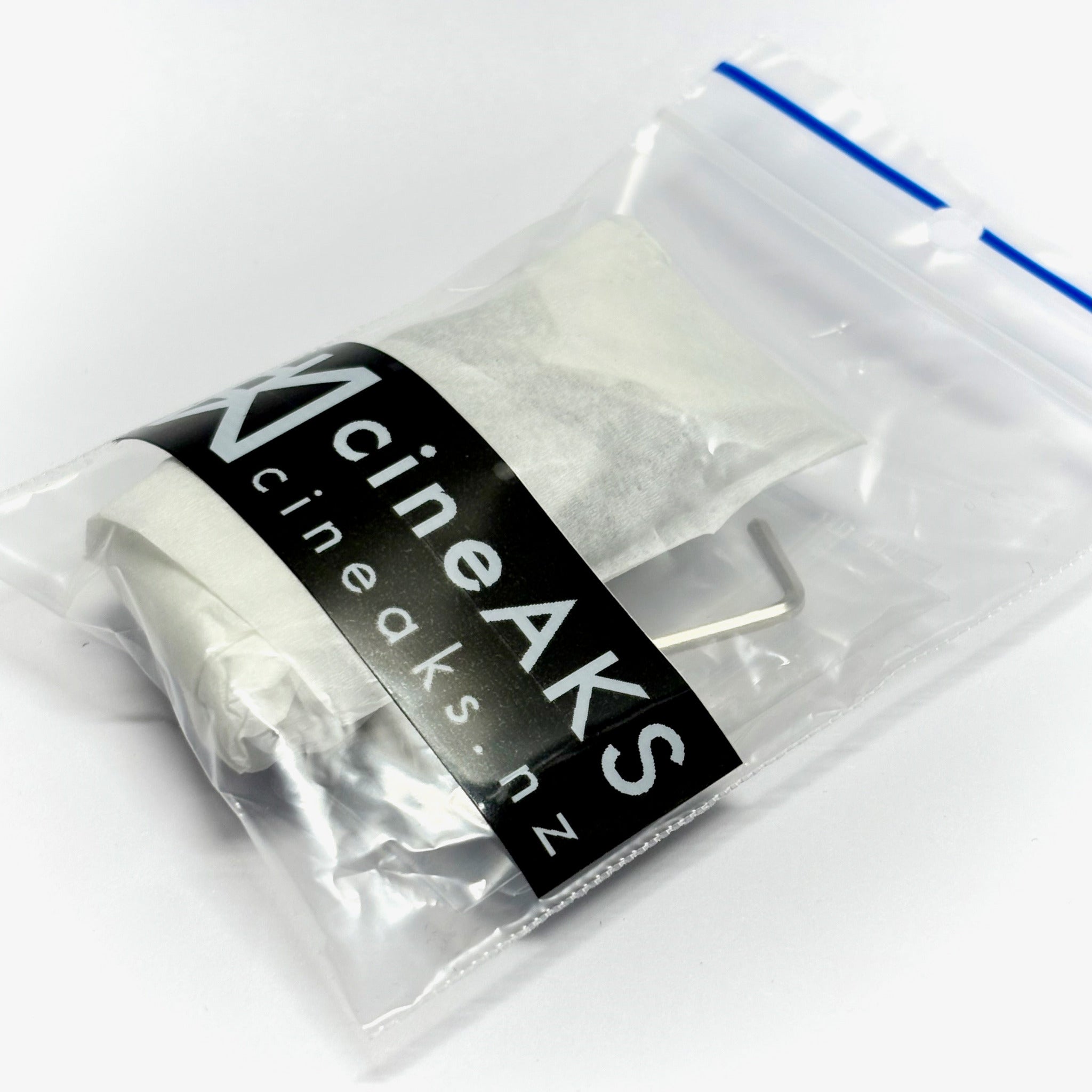 A clear plastic zip-top bag containing MotoCrane TitanLT replacement corner bracket with ARRI locating 3-8-16 thread, sealed with a black label reading 'cineaks.cineaks.
