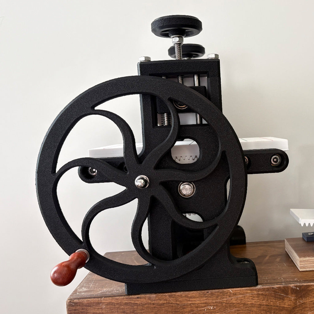 A 3d printed a6 sized etching press on white background