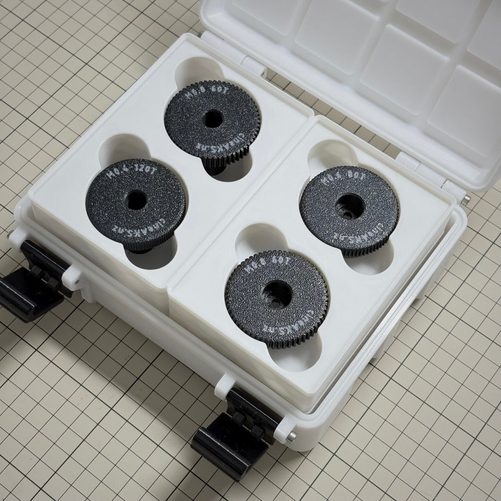 cineAKS cforce gears stored in a 3x4x8U Gridfinity case, photographed on a beige grid surface.