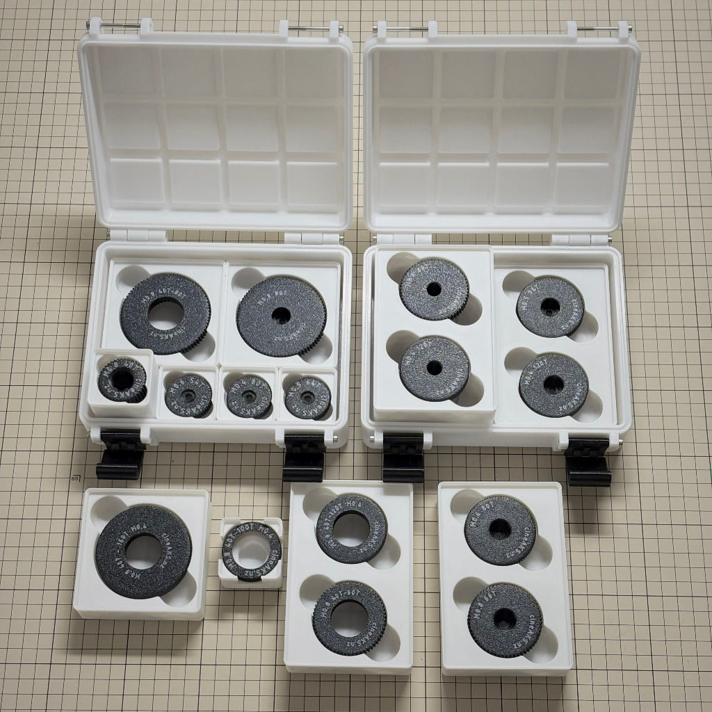 A cineAKS cforce Master Collection 16 gear arri lens focus puller kit with Gridfinity storage on a beige graph paper background.