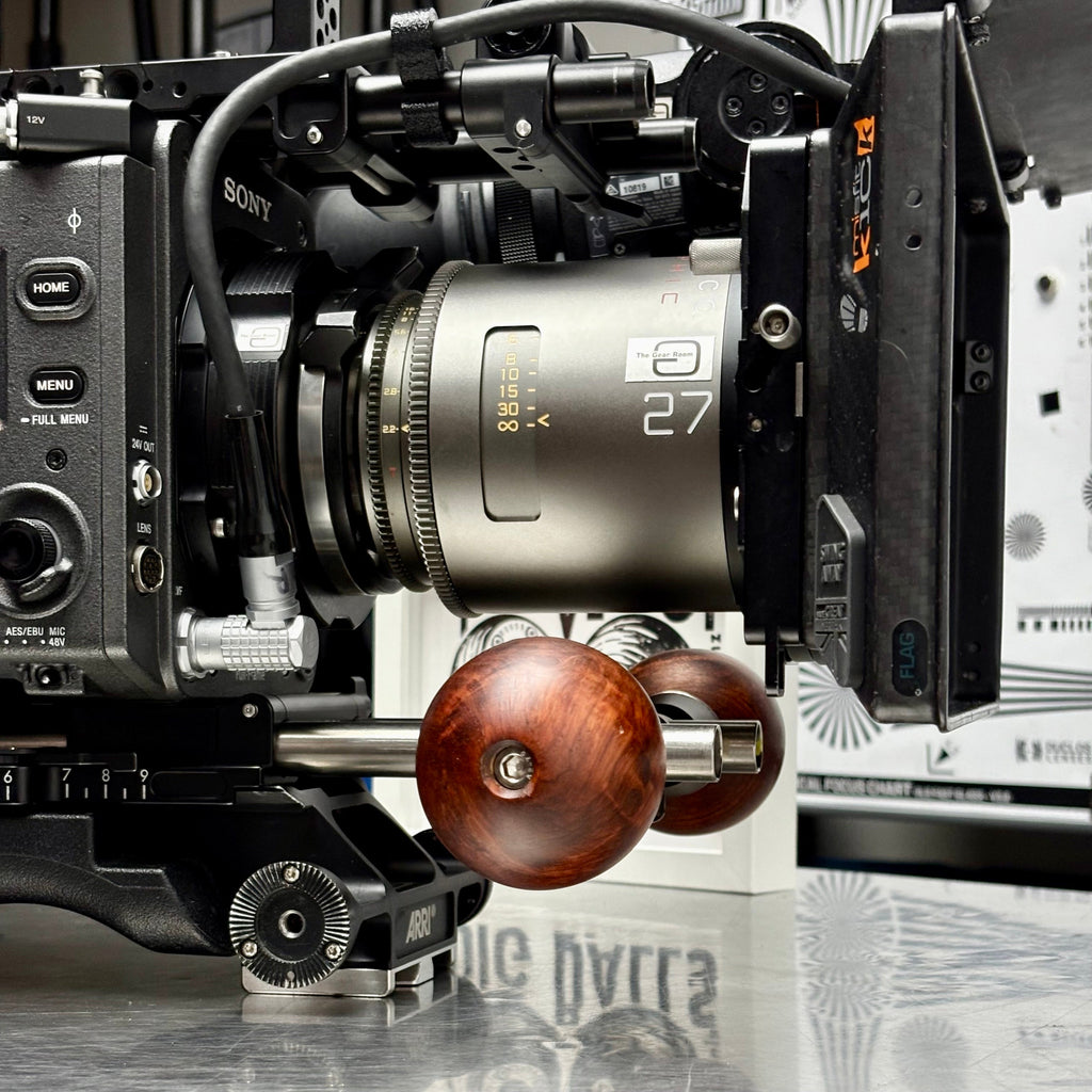 Wooden camera handle on Sony Venice with anamorphic lens on a reflective surface