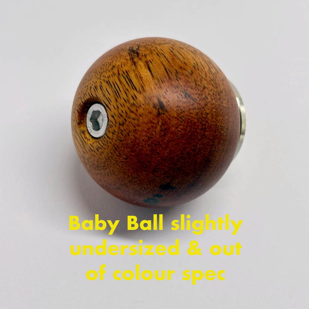 Wooden ball camera handle with text indicating it is slightly undersized and out of color specification on a white background.
