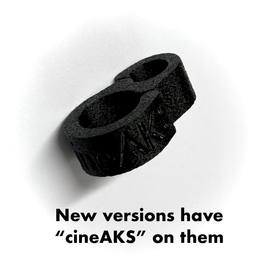 A black 15mm rod camera cable tidy from cineAKS on a white background