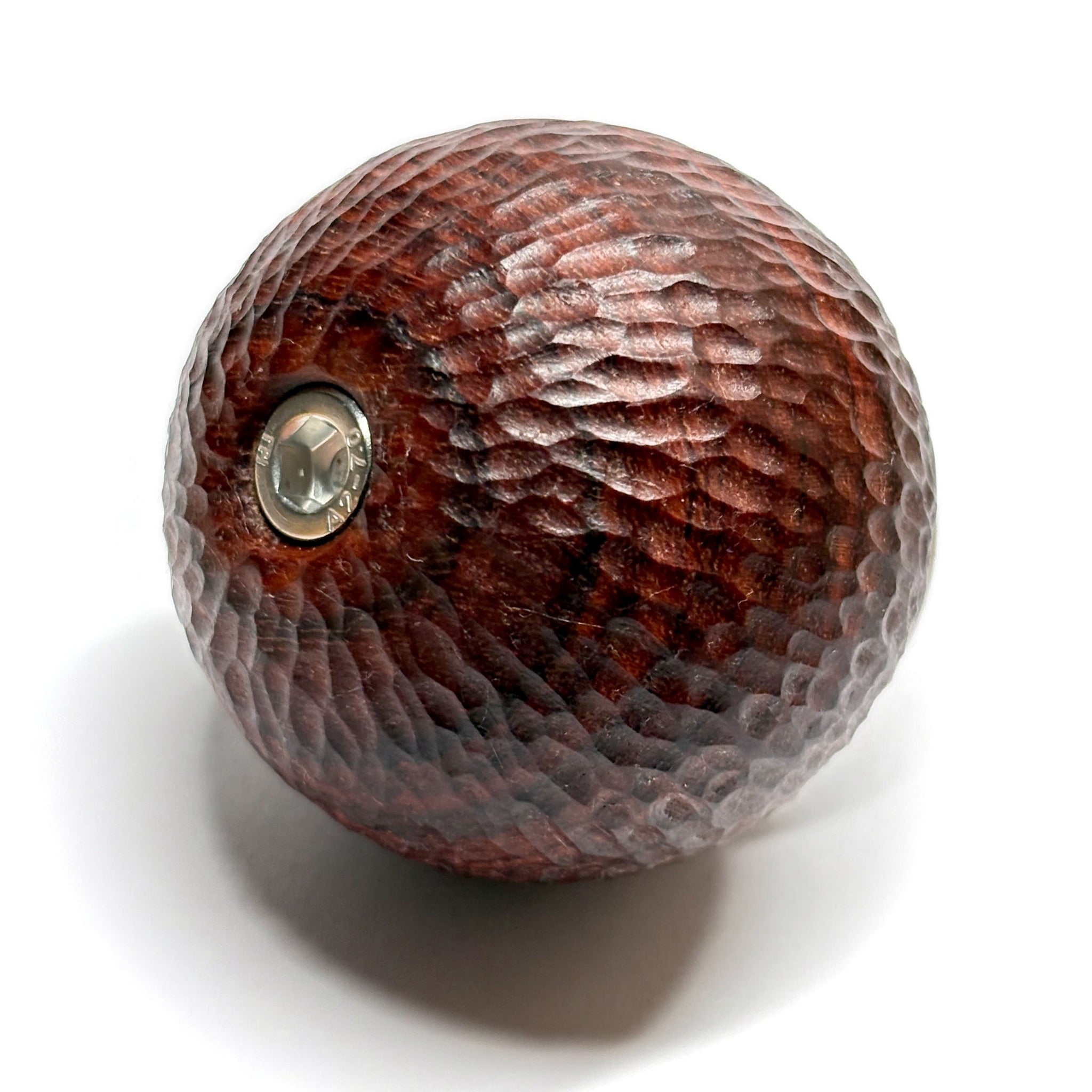 hand carved wooden padauk camera handle with a textured surface on a white background