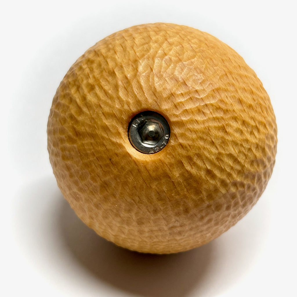 Wooden camera knob handle with a central screw on a white background