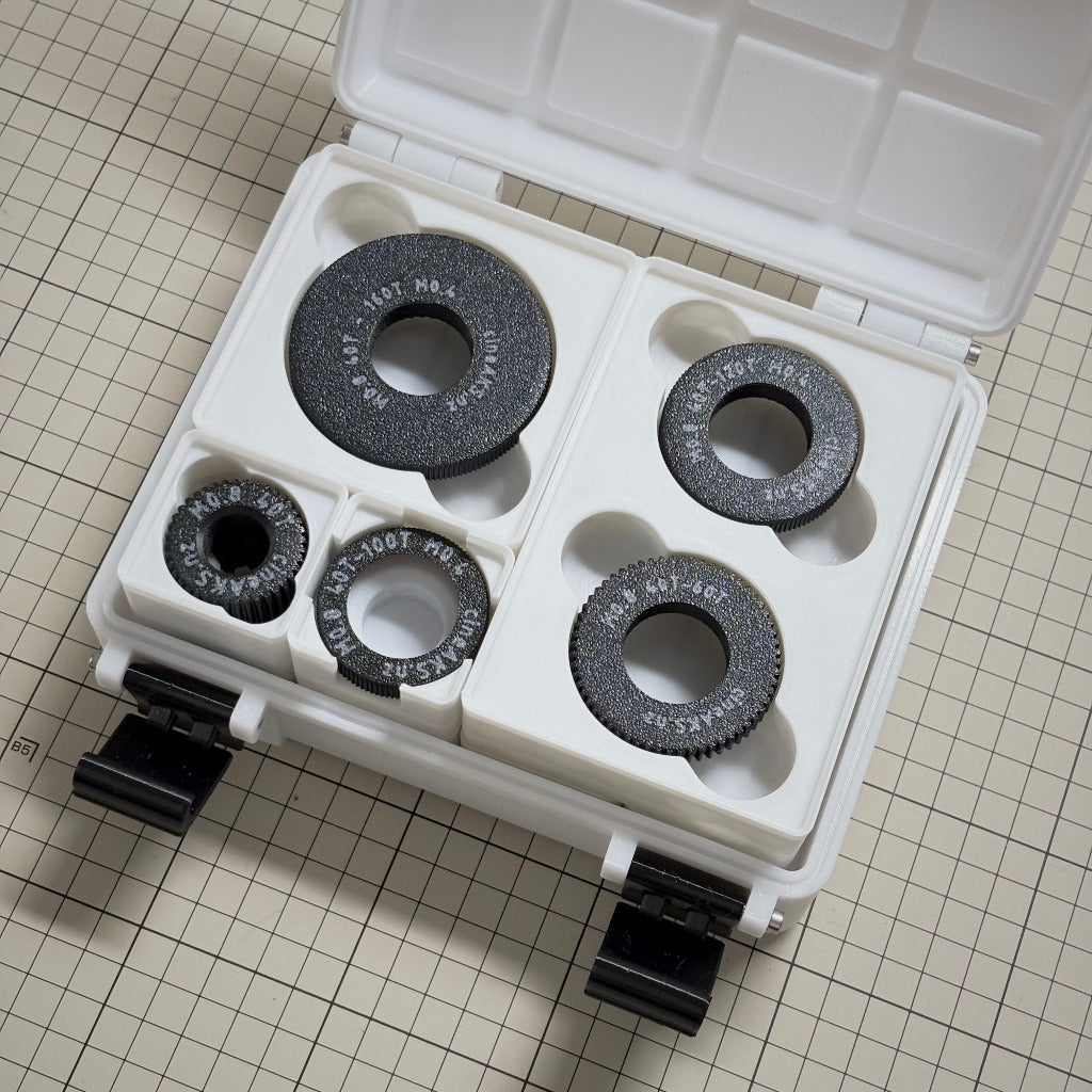 cineAKS arri cforce mini cogs stored in a 3x4x8U Gridfinity case, placed on a beige grid surface.