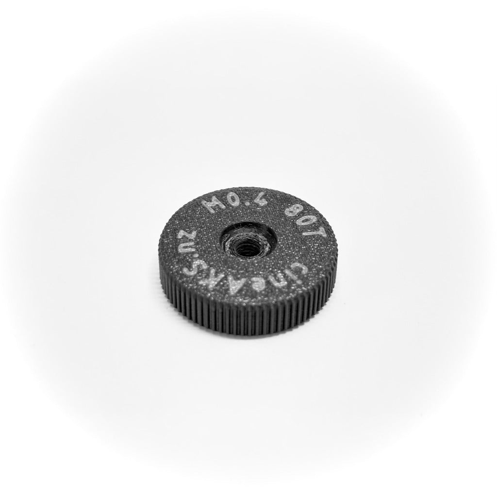M0.4 64 pitch lens gear for older Panavision iris mechanisms, on a white background