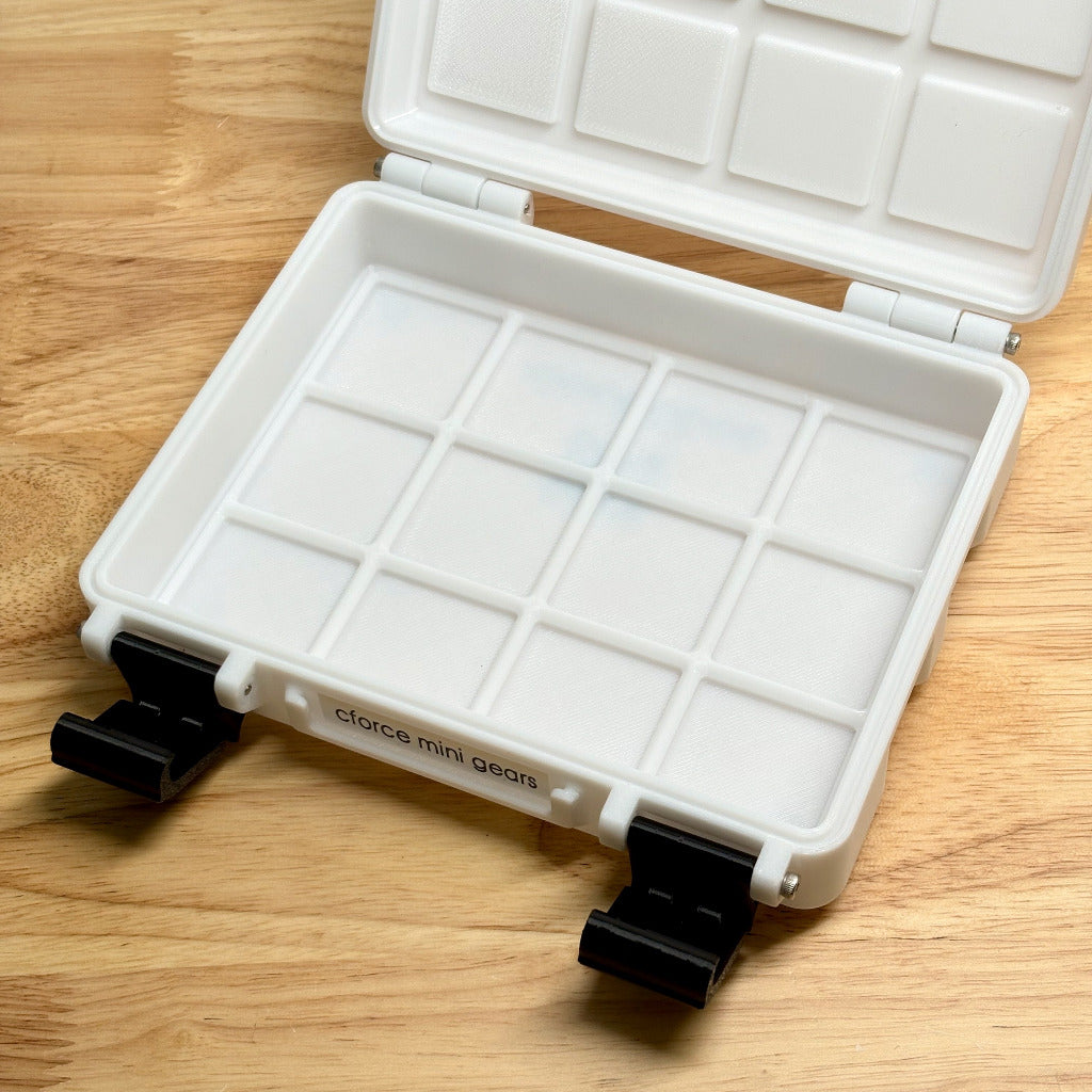 White gridfinity box with compartments on a wooden surface