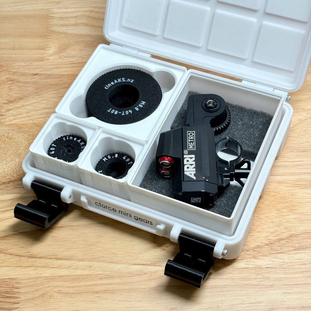 Arri cforce mini motor and lens gear kit in a white carrying case on a wooden surface
