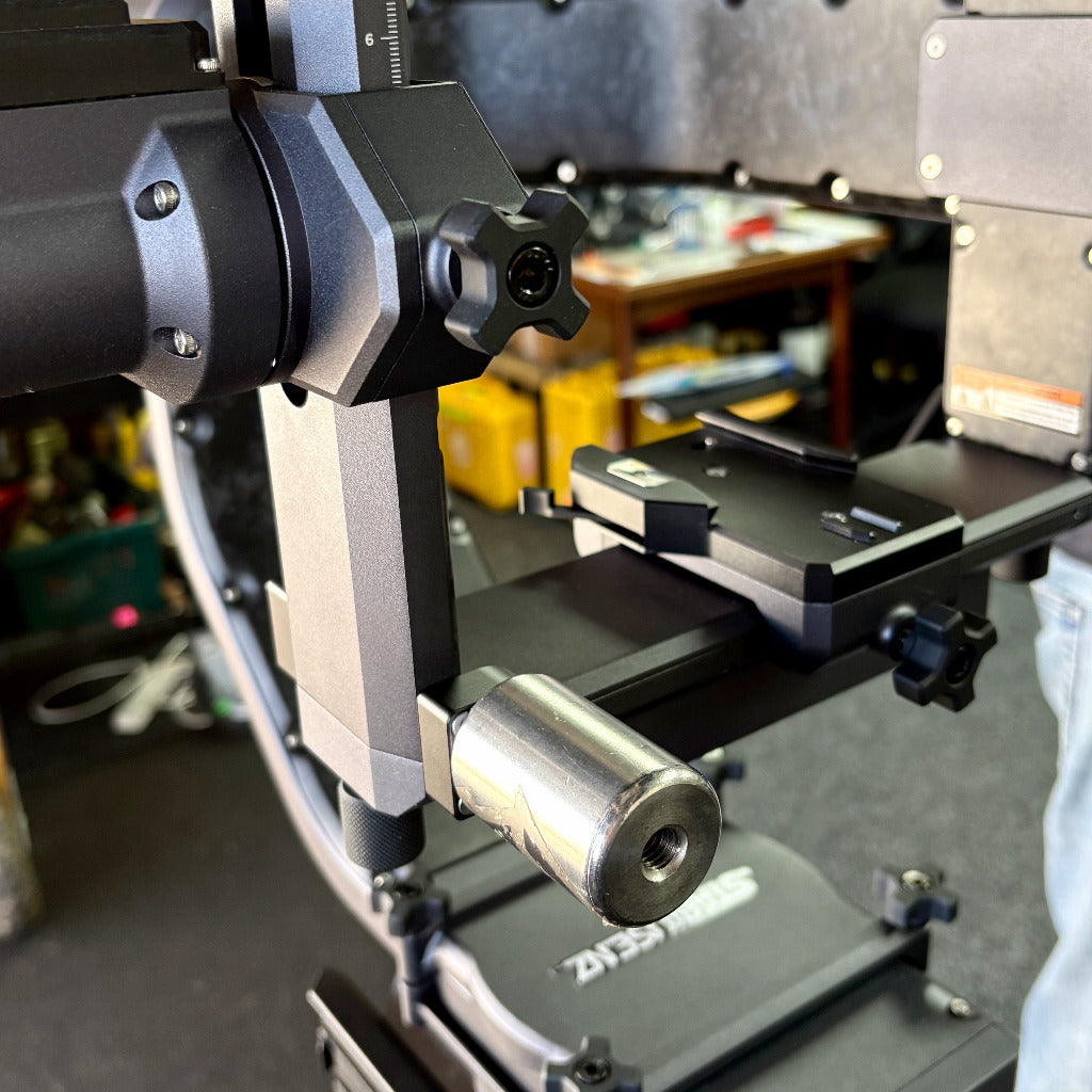 Close-up of a cinemilled gimbal counterweight on a cineaks replacement titan lt head replacement corner bracket, photographed in a workshop setting.