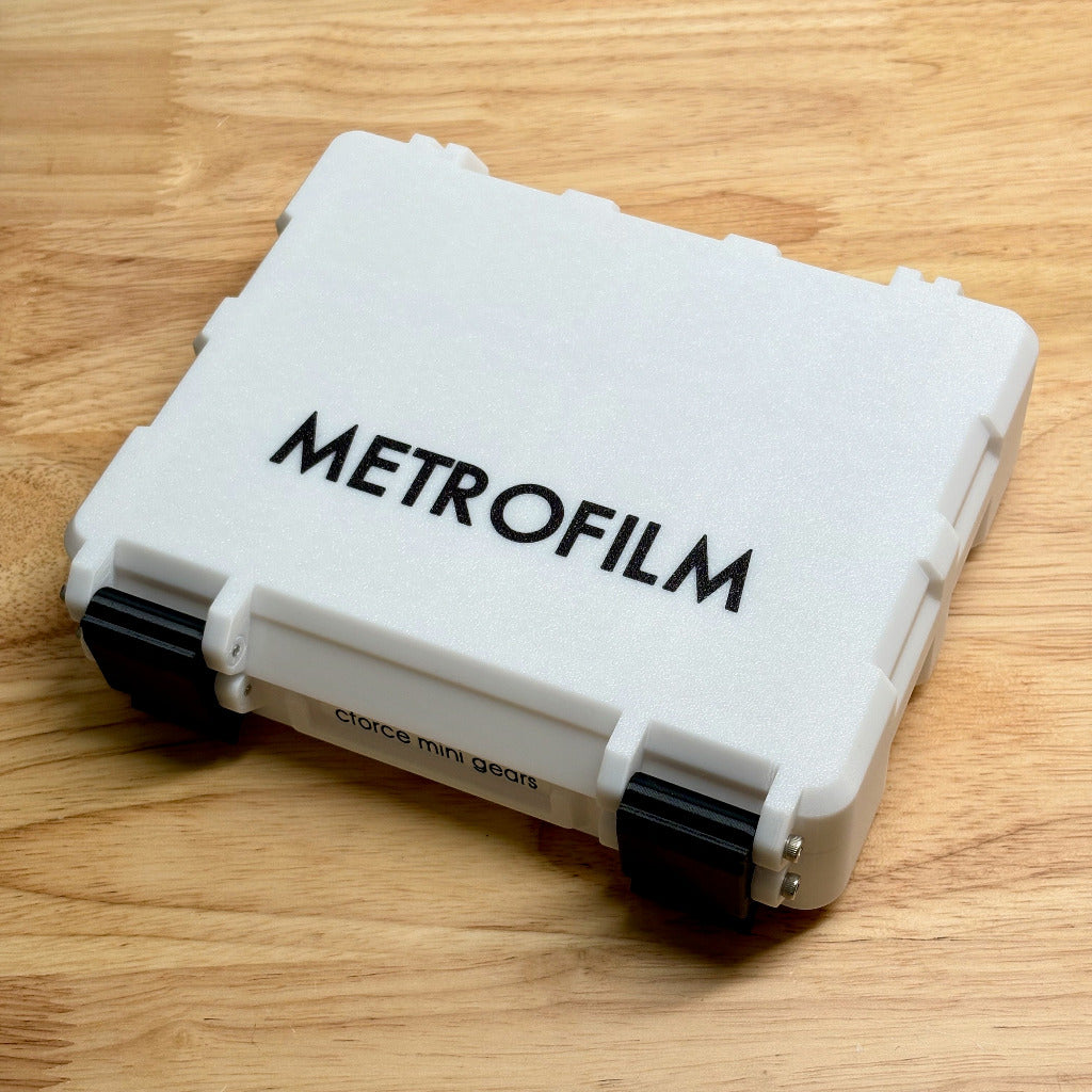 White Metrofilm case on a wooden surface