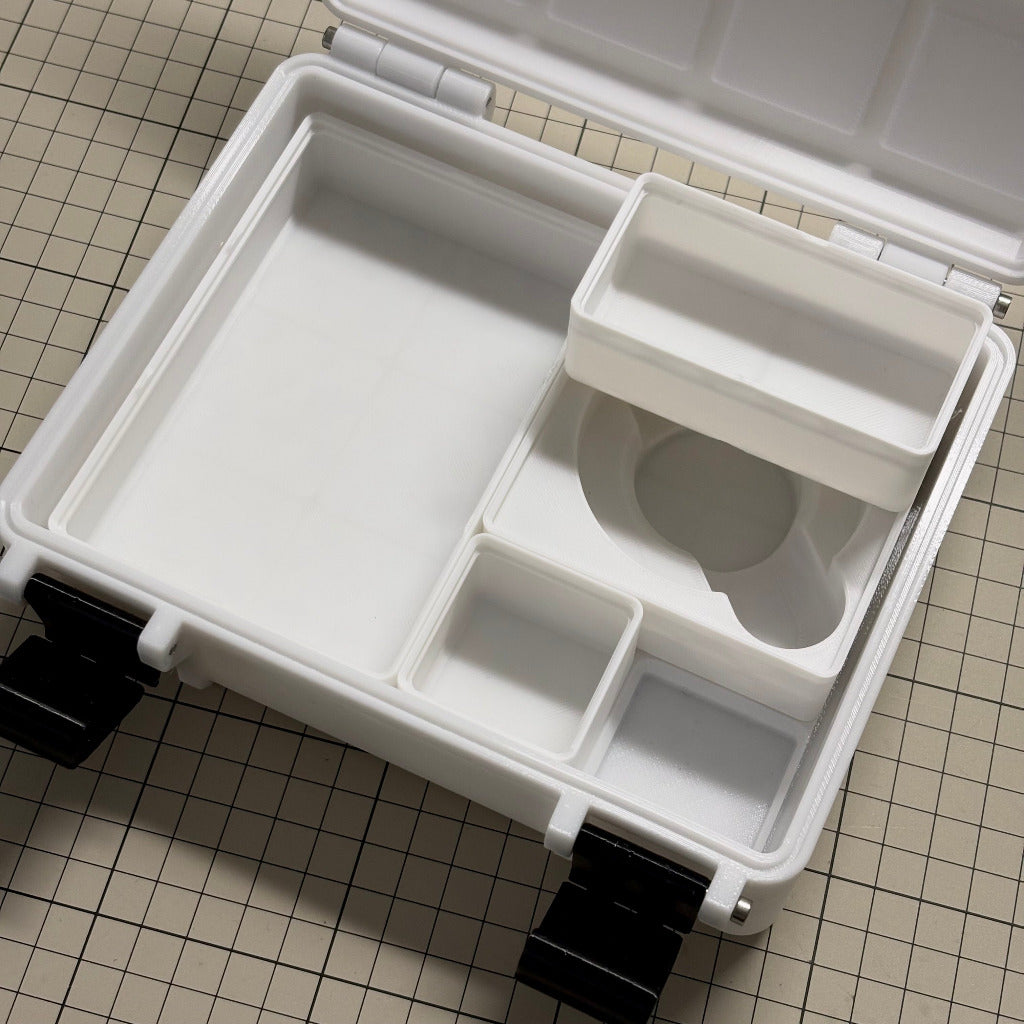 ARRI cforce Mini and CLM-5 gear storage cases and Gridfinity bins by cineAKS. The case is photographed from above on a beige grid-patterned surface.