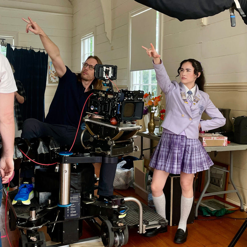 Hendrikus De Vaan and Shervonne Grierson on a film set both pointing next to a Panther dolly with a Moy Geared Head and FX6 camera