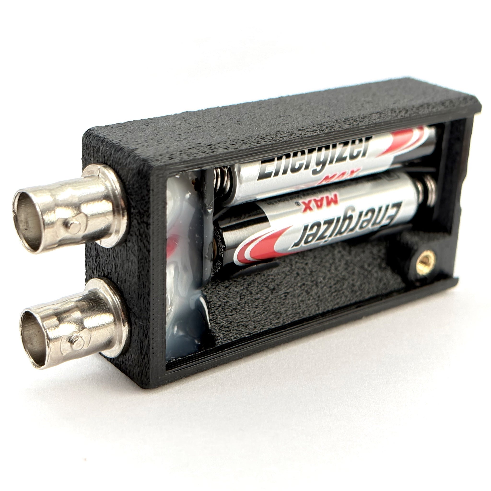 bnc cable continuity tester open showing batteries, on a white background.