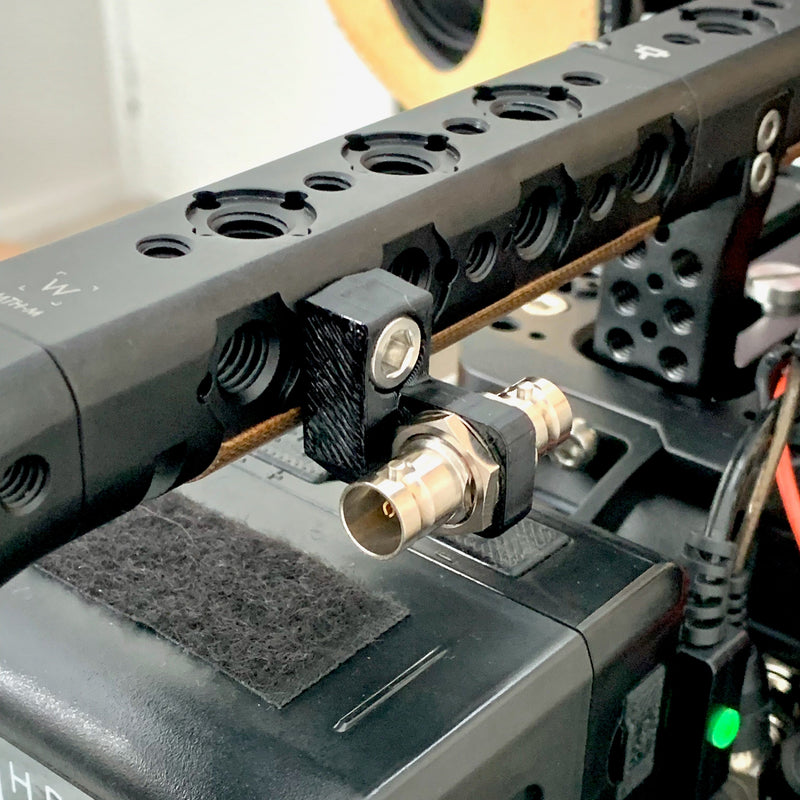 SDI strain relief bracket attached to wooden camera master handle