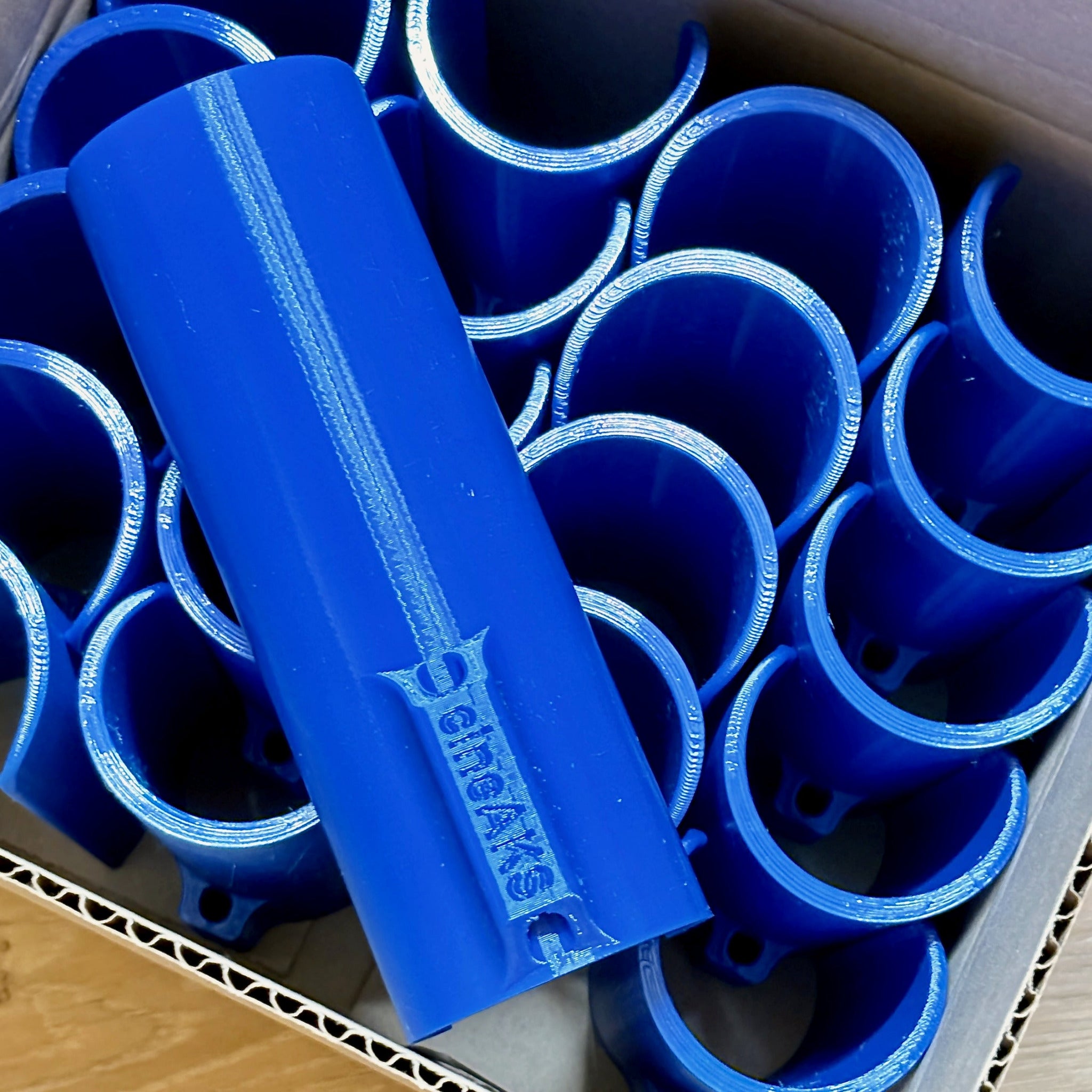 A carton box full of blue coloured speed rail speed clips.